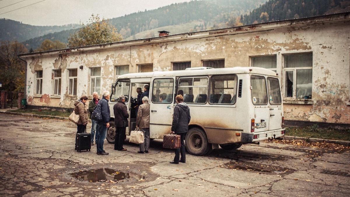 Minibus waiting at a mountain station platform in the Carpathians before the afternoon transfer